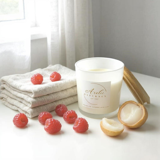 Aretii Champagne Red Berries coconut wax candle in white glass jar with white label and bamboo lid.