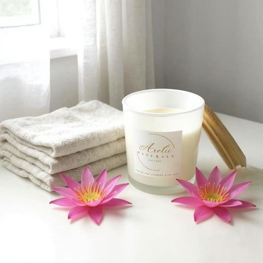 Aretii Pink Waterlily coconut wax candle in white glass jar with white label and bamboo lid.